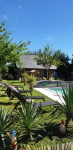 a resort with a swimming pool and a house at LES HIRONDELLES in Ingouville