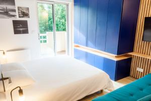 a bedroom with a bed and a blue wall at 8 min de la plage, 2 de la gare, 15 de St-Nazaire in La Baule