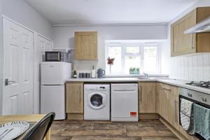 een keuken met een wasmachine en droger. bij Modern Spacious 2 Bedroom Apartment in Brentwood in Shenfield