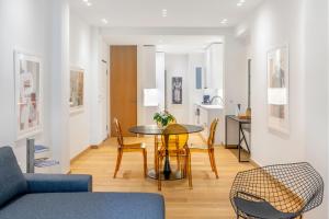 a living room and dining room with a table and chairs at Luxury 1BR Flat in the Heart of Athens in Athens