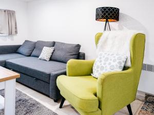 a living room with a couch and a chair at Penzion Labská Vyhlídka in Litoměřice