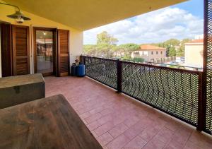 a balcony with a bench and a view of the city at Murphy Holiday Home - Residenza Aldo Moro 02 in La Maddalena