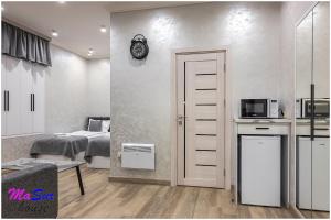 Zimmer mit einem Bett und einer Küche mit einer Mikrowelle in der Unterkunft Masur House and Tours in Yerevan