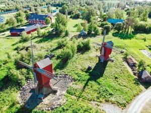 an aerial view of a farm with a windmill at Vindsvåning i Harrström in Korsnäs