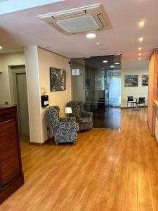 an empty lobby with chairs and tables in a building at Hotel 1948 Manresa in Manresa