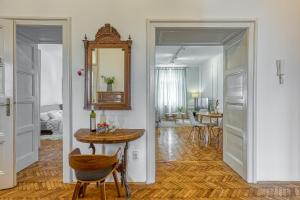 a living room with a table and a mirror at Spacious Apartment In Heart Of Zagreb - Happy Rentals in Zagreb