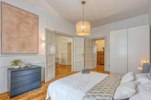 a bedroom with a bed and a blue dresser at Spacious Apartment In Heart Of Zagreb - Happy Rentals in Zagreb