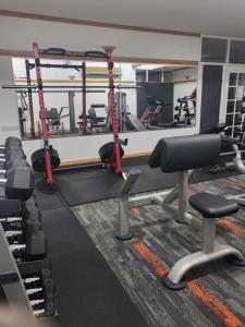 a gym with several treadmills and tread machines at Banksia Motel in Collie
