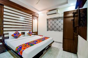 a bedroom with a large bed in a room at FabHotel Trishiv - Newtown Kolkata in Kolkata