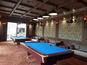 two pool tables in a room with couches at Dreamland Oasis apartment Chakvi in Chakvi