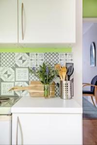 a kitchen with white cabinets and a white counter top at Fourwinds in Maldon