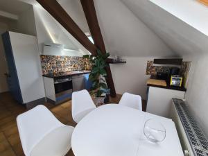 eine Küche mit einem weißen Tisch und weißen Stühlen in der Unterkunft Villa in Adelsheim in Adelsheim