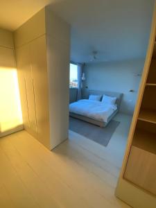 a bedroom with a white bed in a room at best sea view boutique two bedrooms in Herzliya