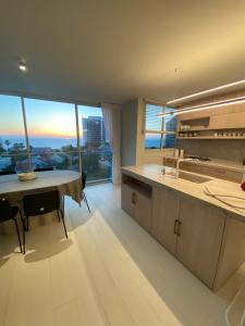 a kitchen with a table and a large window at best sea view boutique two bedrooms in Herzliya