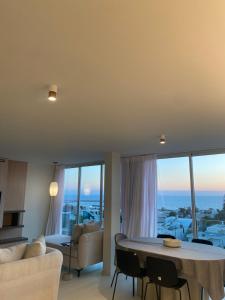 a living room with a table and chairs and a couch at best sea view boutique two bedrooms in Herzliya