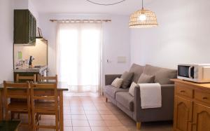 a living room with a couch and a table at Grupoandria Aparthotel Club Andria in Cala Santandria