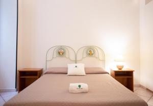 a bedroom with a bed with two towels on it at Casetta Diana - The Fab Stay in Brindisi