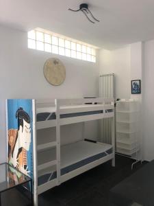 Zimmer mit 2 Etagenbetten und einer Uhr an der Wand in der Unterkunft Casa Gaiani Villetta in riva al lago vista mozzafiato in Varano Borghi