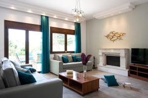 a living room with a couch and a fireplace at Villa Iasama in Rhodes Town