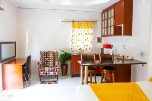 a kitchen with a table and chairs in a room at Eagles Nest Self-Catering Apartments in Gaborone