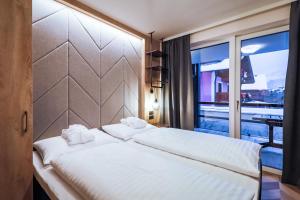 Łóżko lub łóżka w pokoju w obiekcie 24 by AvenidA - Mountain Hotel