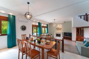 a dining room and living room with a table and chairs at Villa Iasama in Rhodes Town
