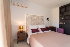 a bedroom with a large white bed with two pillows at Villa Iasama in Rhodes Town +41 photos