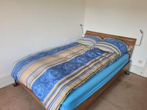 a bed with colorful blankets and pillows on it at Villa in Adelsheim in Adelsheim