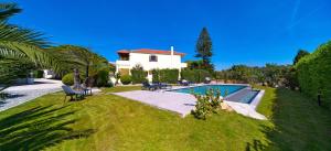 a house with a swimming pool in a yard at Villa Iasama in Rhodes Town