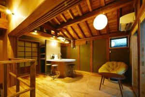 a room with a table and a chair in a room at MUSIRO STAY and SAUNA in Yokote