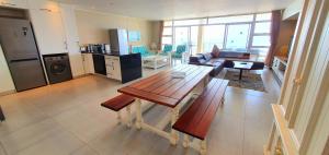 a kitchen and living room with a table and a couch at La Mer 8 - 6 Sleeper - Overlooking Margate Beach! in Margate