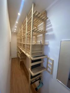 a room with wooden shelves on a wall at Moonlight Apartman in Sárospatak