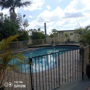 een zwembad met een hek eromheen bij Neat and cosy cottage with pool - 2103 in Harare