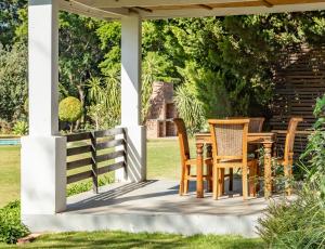 a porch with a table and chairs on it at Hopefield BnB in Addo