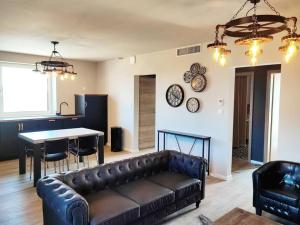a living room with a couch and a table at Vue splendide au coeur des vignes in Bergheim