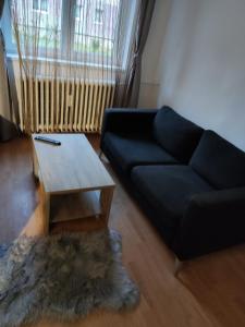 een woonkamer met een bank en een salontafel bij Bo Apartment in Miercurea-Ciuc
