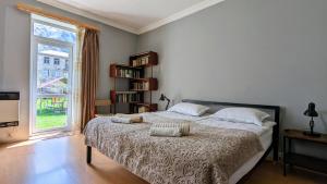 a bedroom with a large bed and a window at Kazbegi Green Yard in Kazbegi