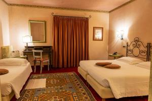 Postel nebo postele na pokoji v ubytování Hotel Boccaccio