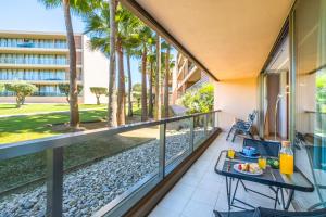 a balcony with a table and chairs and palm trees at Apartment Salgados by Algarve Vacation in Albufeira +42 photos