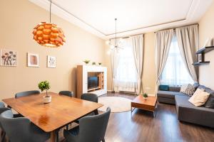 a living room with a table and a couch at Spacious Luxury apartment at the heart of Budapest in Budapest