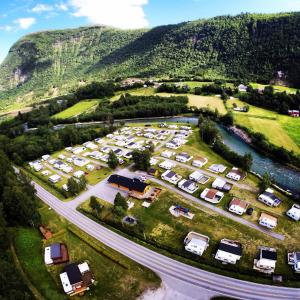 an aerial view of a parking lot in front of a mountain at Valldal Camping in Valldal
