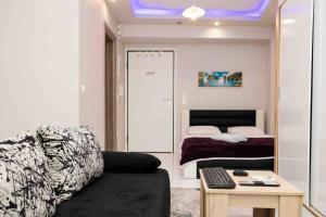 a living room with a couch and a bed at Luxury studio in downtown (4) in Thessaloniki