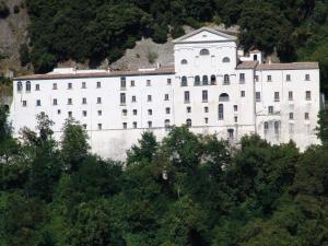 a large white building on the side of a mountain at Villa Marika in Dragonetti