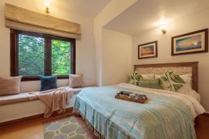 a bedroom with a bed and a window at StayVista at Mawi Infinitty Beach View Villa - Arambol in Arambol +22 photos