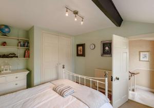 a bedroom with a bed and a book shelf at Kingston House in West Witton
