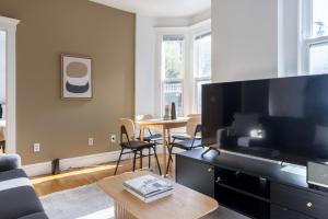 a living room with a large flat screen tv at Beacon Hill 2br w wd nr Boston Common BOS-826 in Boston