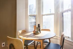 a table and chairs in a room with windows at Beacon Hill 2br w wd nr Boston Common BOS-826 in Boston