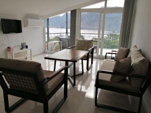 a living room with a couch and a table and chairs at DURU selimiye konukevi in Selimiye