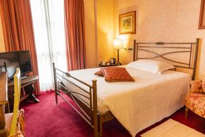 Postel nebo postele na pokoji v ubytování Hotel Boccaccio