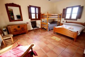a room with two bunk beds and a mirror at TODIMER FINCA ALPUJAREÑA in Vélez de Benaudalla